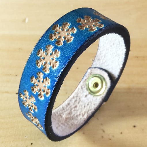 Snowflakes on handmade blue leather bangle